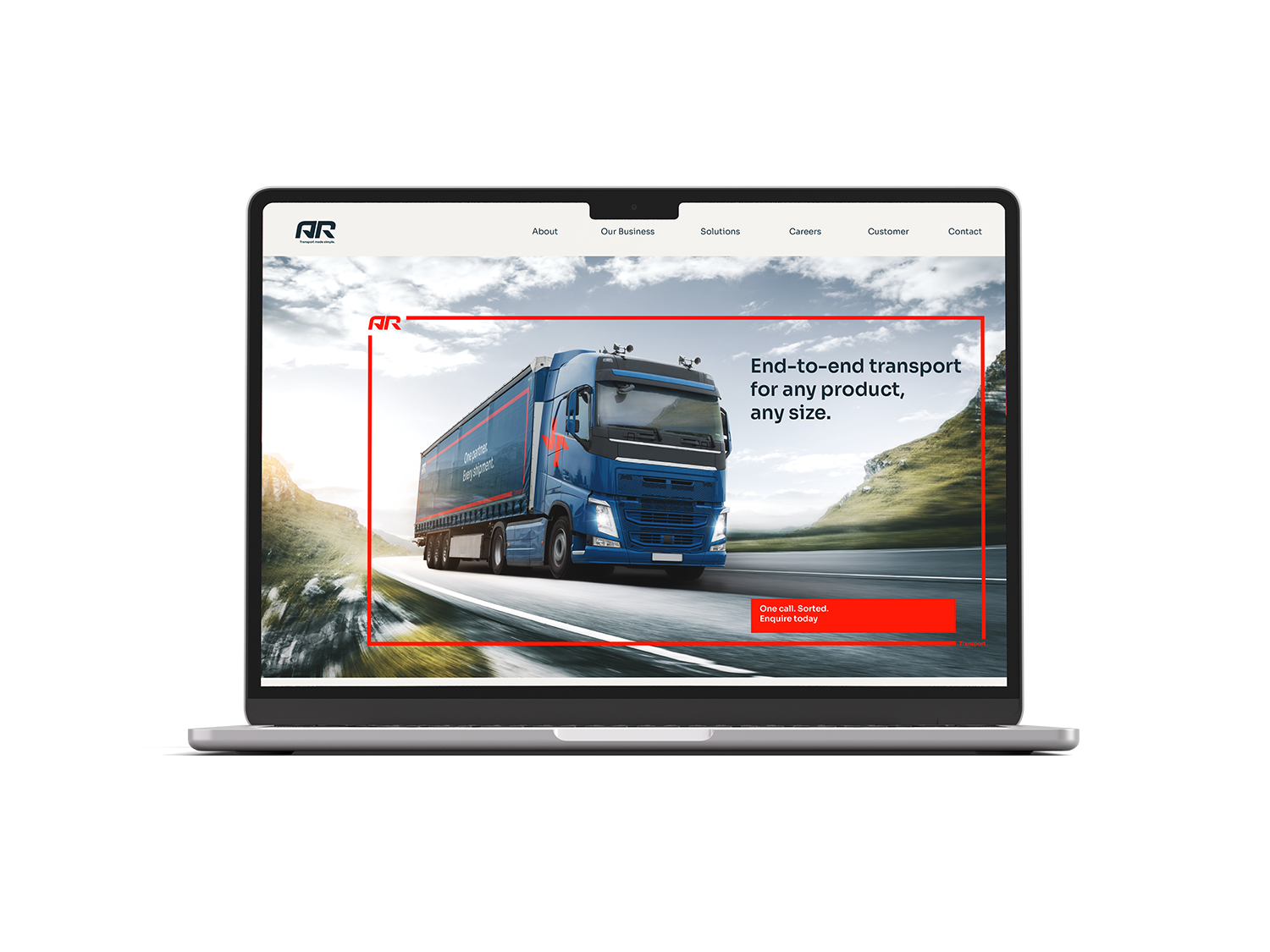 A laptop displaying a transportation company's website featuring a blue freight truck on a highway with mountains and sky in the background, and text about end-to-end transport solutions.