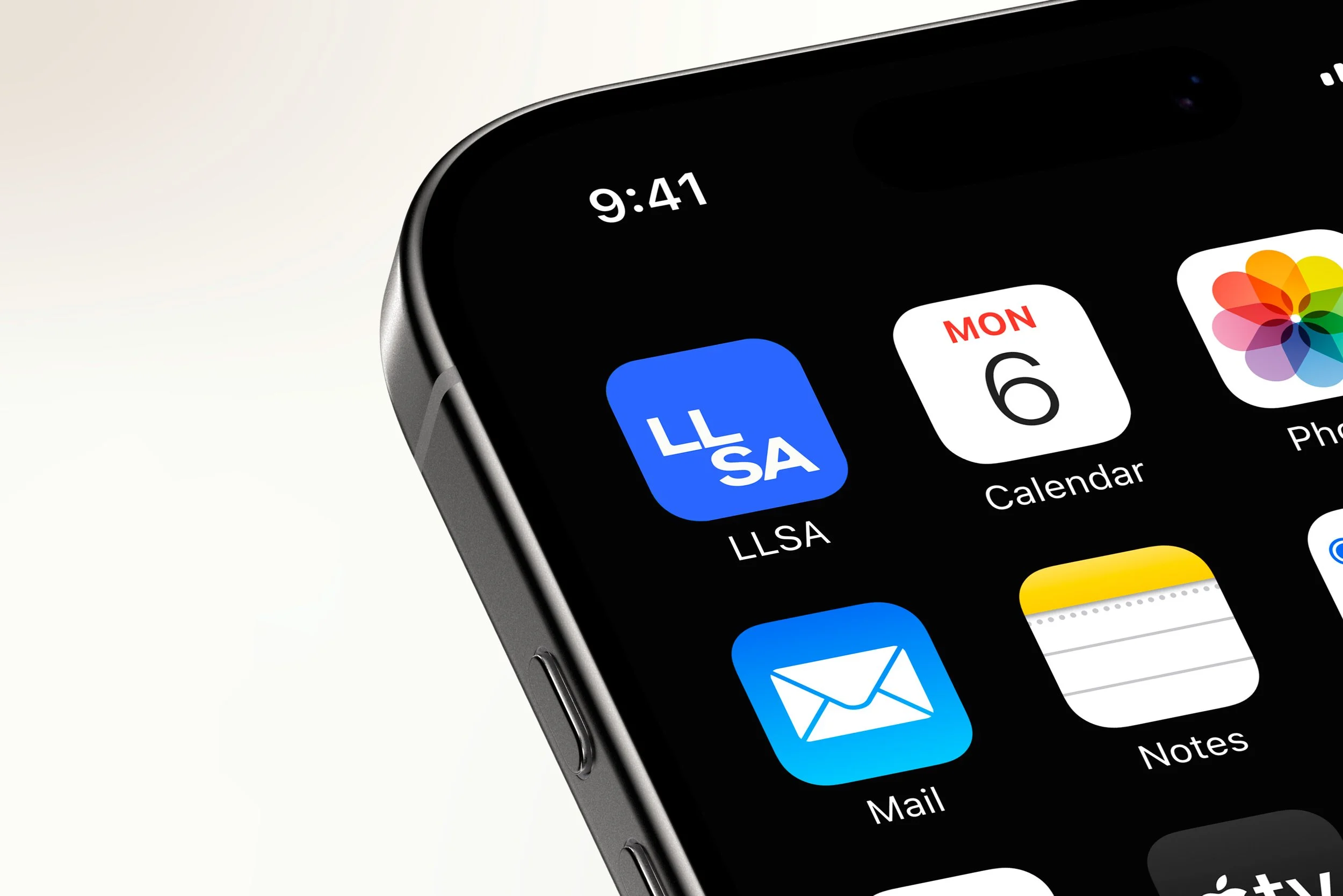 A close-up of a smartphone screen showing app icons, including LLSA, Calendar, Photos, Mail, and Notes, with the time 9:41 in the top left corner.
