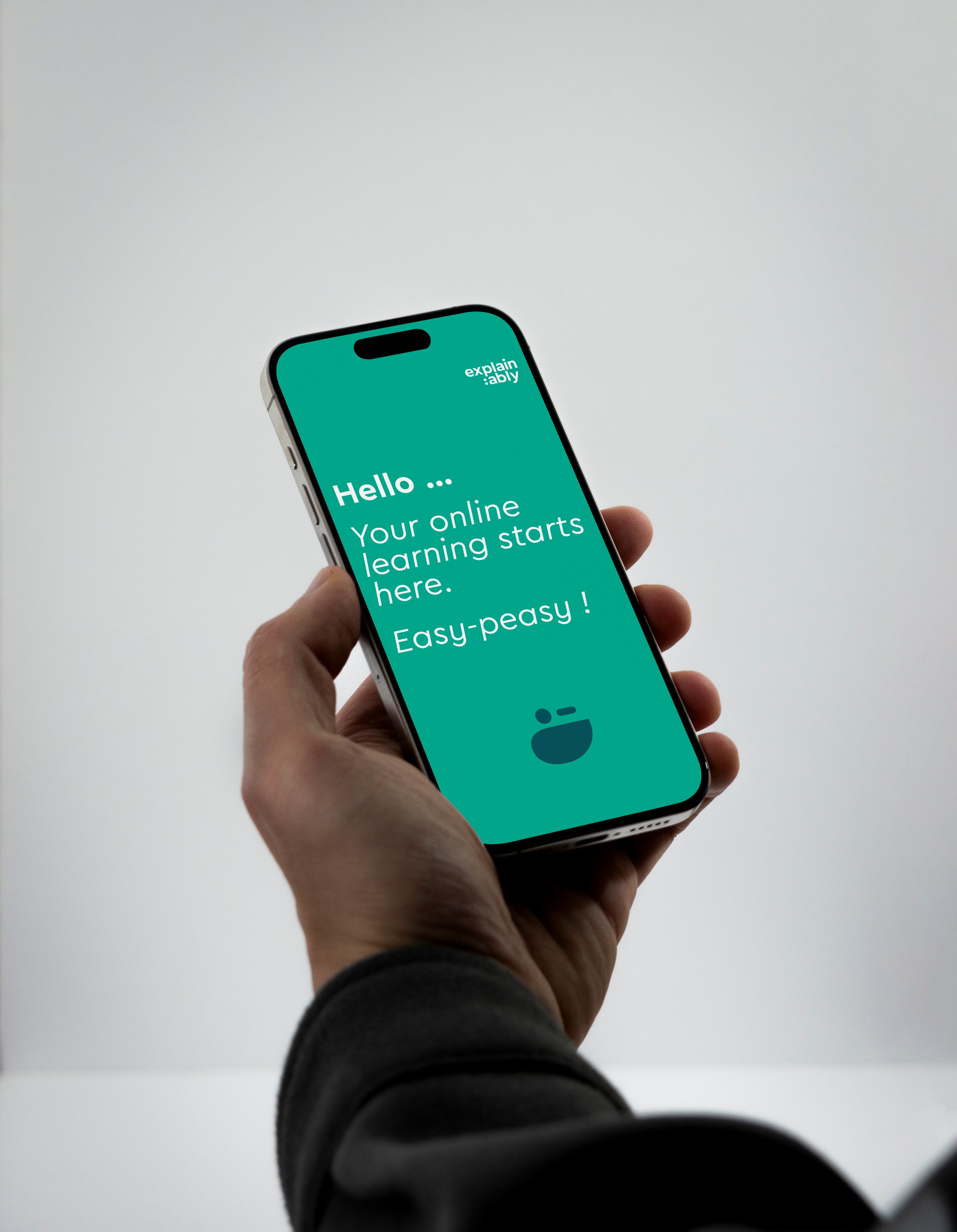 Guy holding his cellphone while browsing through the Explain:ably app - easy peasy!