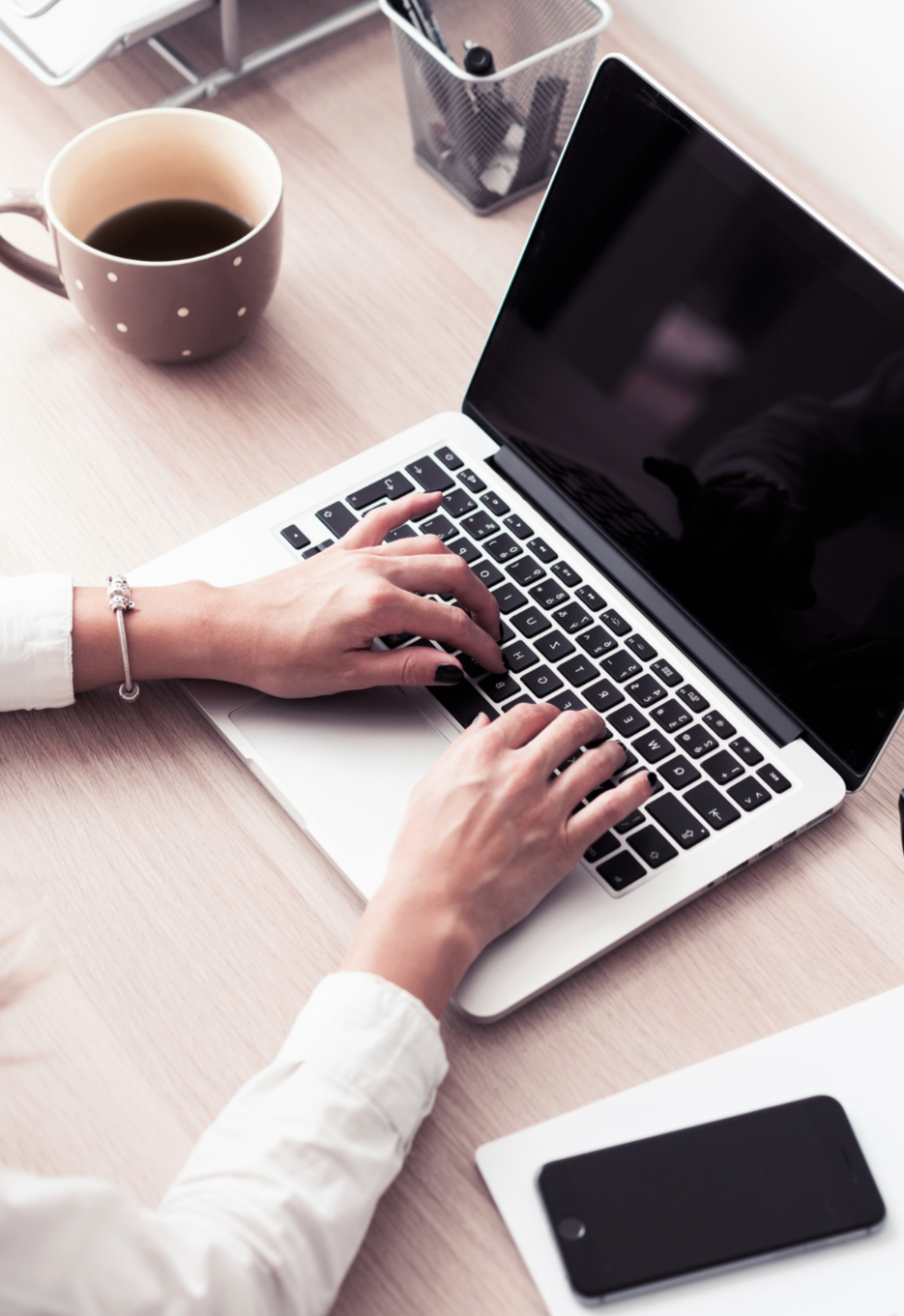 Hands typing on a laptop, showing work for a boutique studio offering website design and SEO strategy services for evolving small businesses.