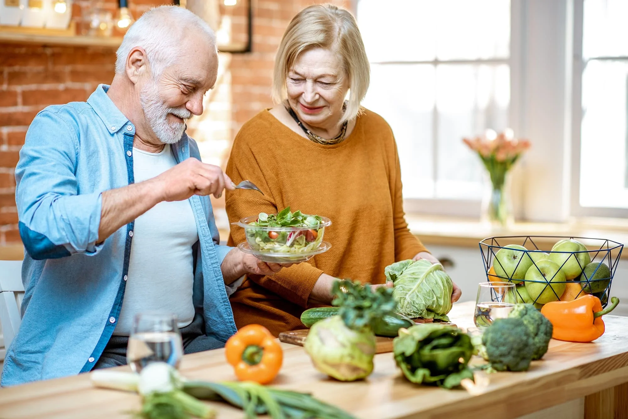 Older couple preparing a meal together in their kitchen