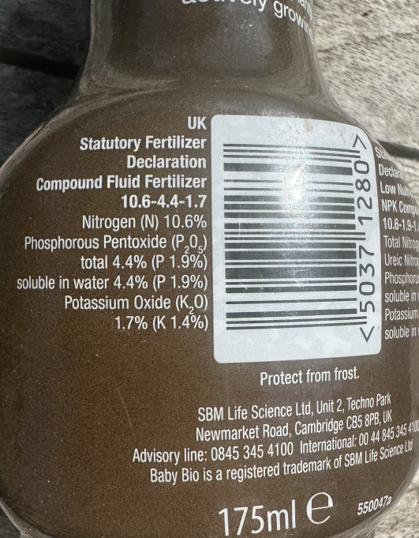 Close-up of a fertilizer bottle label showing the numerical NPK composition codes.