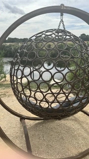 A suspended swing chair by the river
