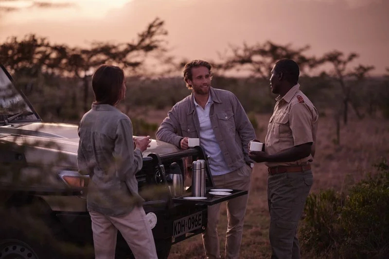Young couple enjoying a morning coffee break in the African bush during a private game drive
