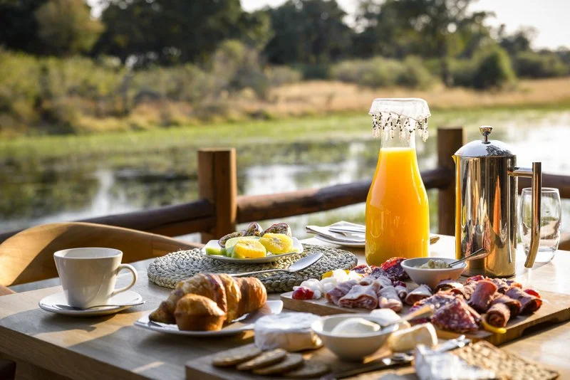 Appealing breakfast spread with coffee overlooking an African river