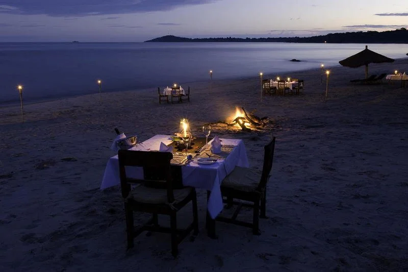 Romantic sunset dinner on the shores of Lake Malawi, Malawi.