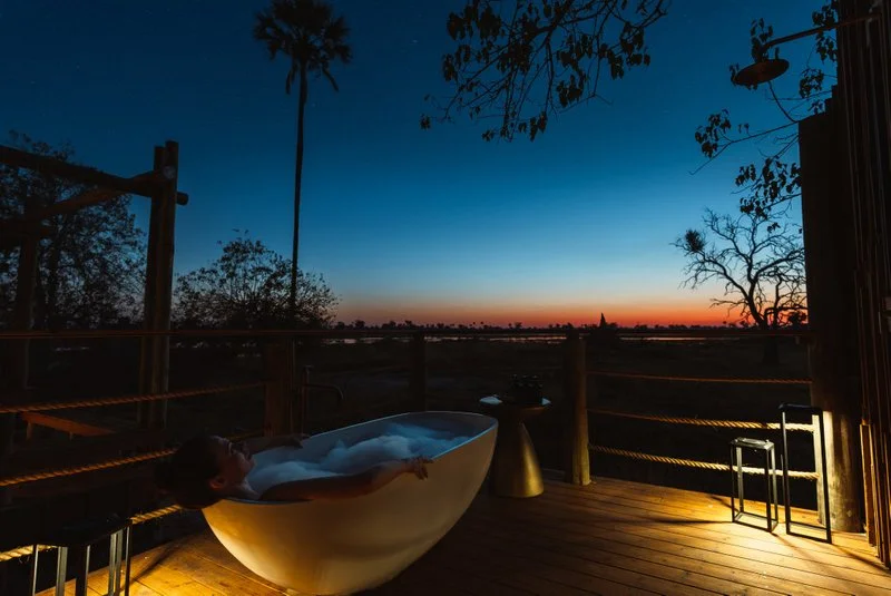 Evening private bubble bath on a lodge room deck under the African stars