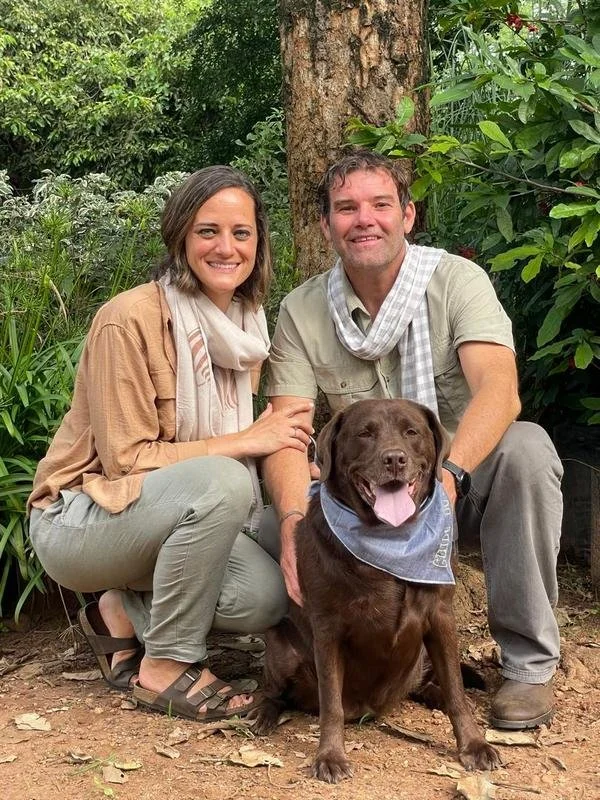 Husband and wife, Warren and Megan Baty, owners and directors of African Footprints LLC in Malawi, with their chocolate Labrador