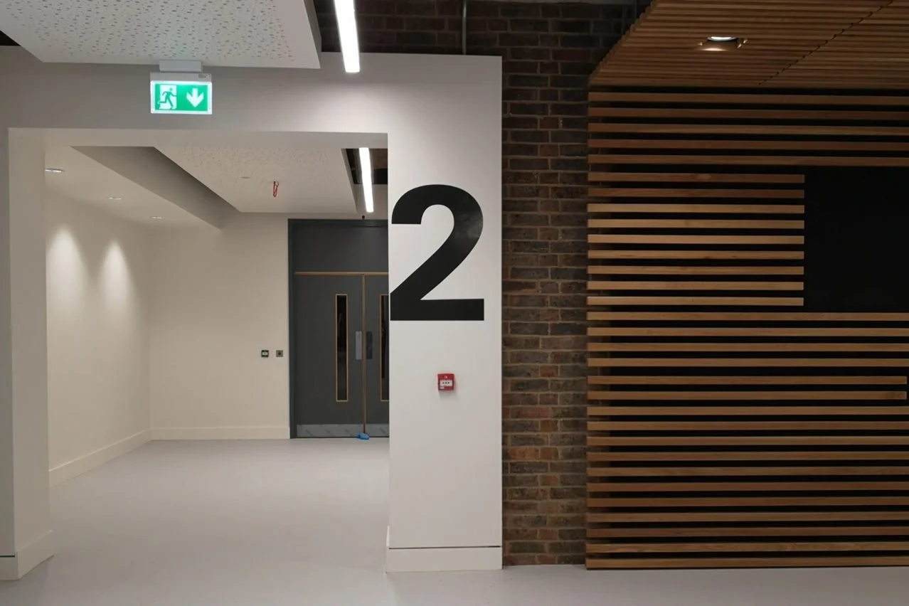 Fire exit statutory signage in office corridor