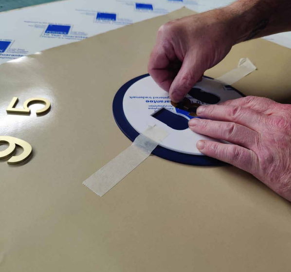 taping letters on a door sign