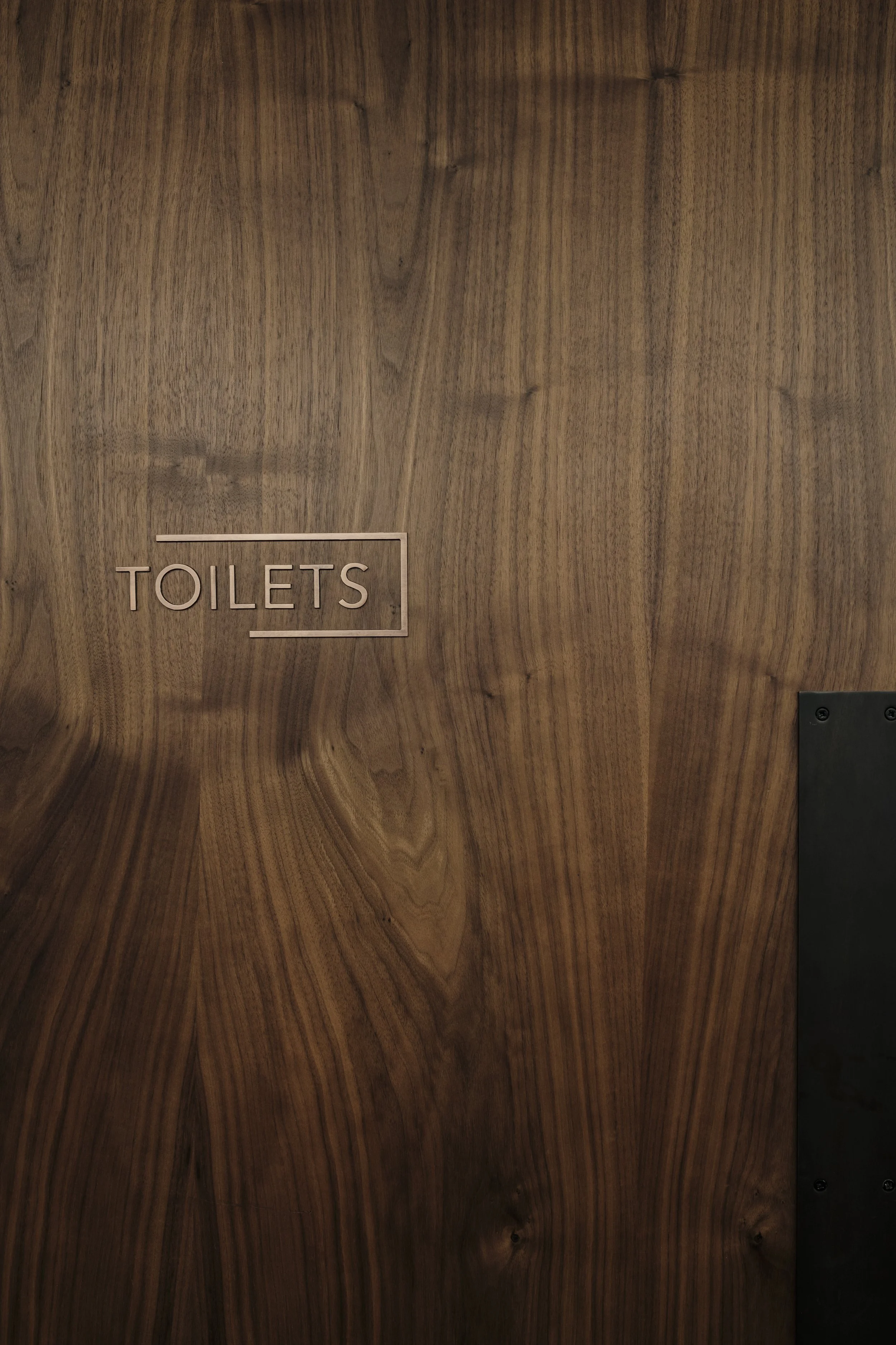 Toilet sign on wooden door