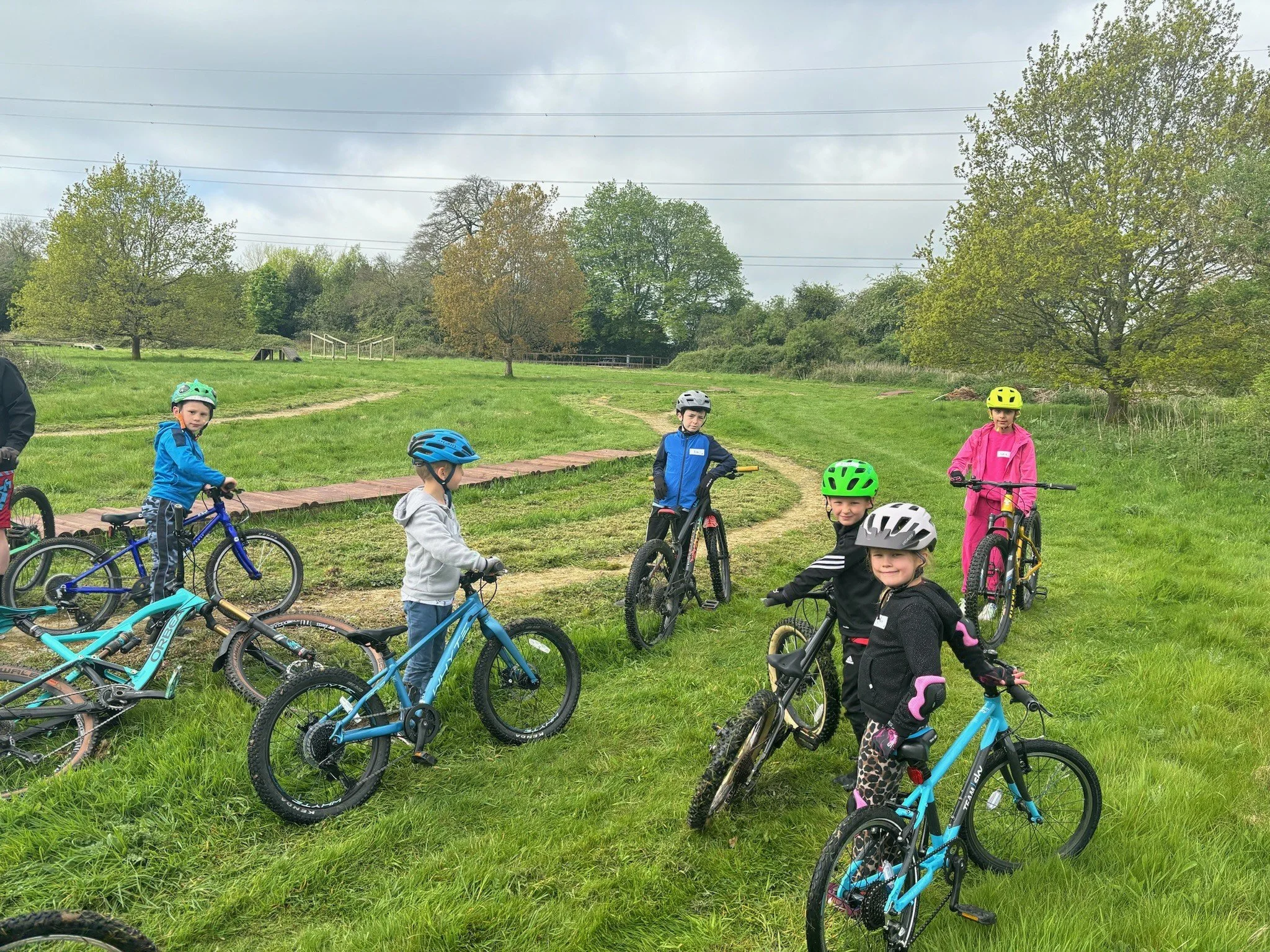 Mixed group of children on their mountain bikes in a park