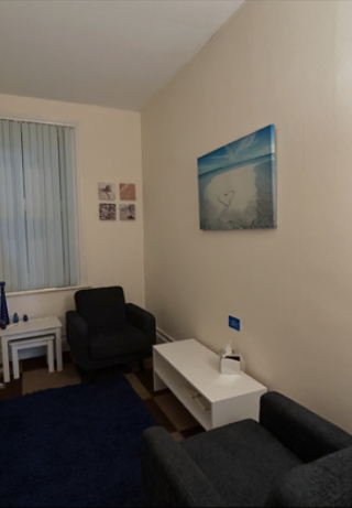 Counselling room in Worthing with warm lighting and décor.