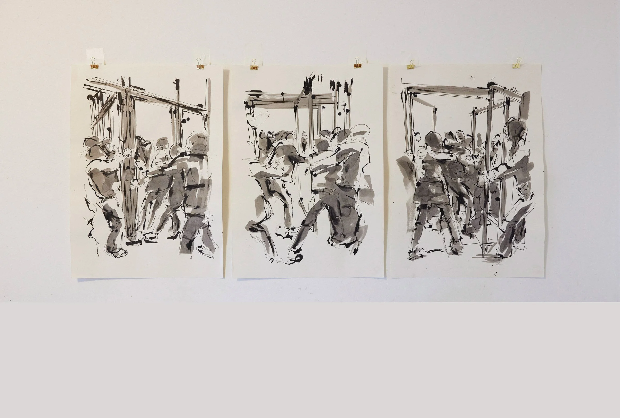 Three black and white sketches of people interacting in a confined space, possibly an art installation or exhibit, displayed on a white wall.