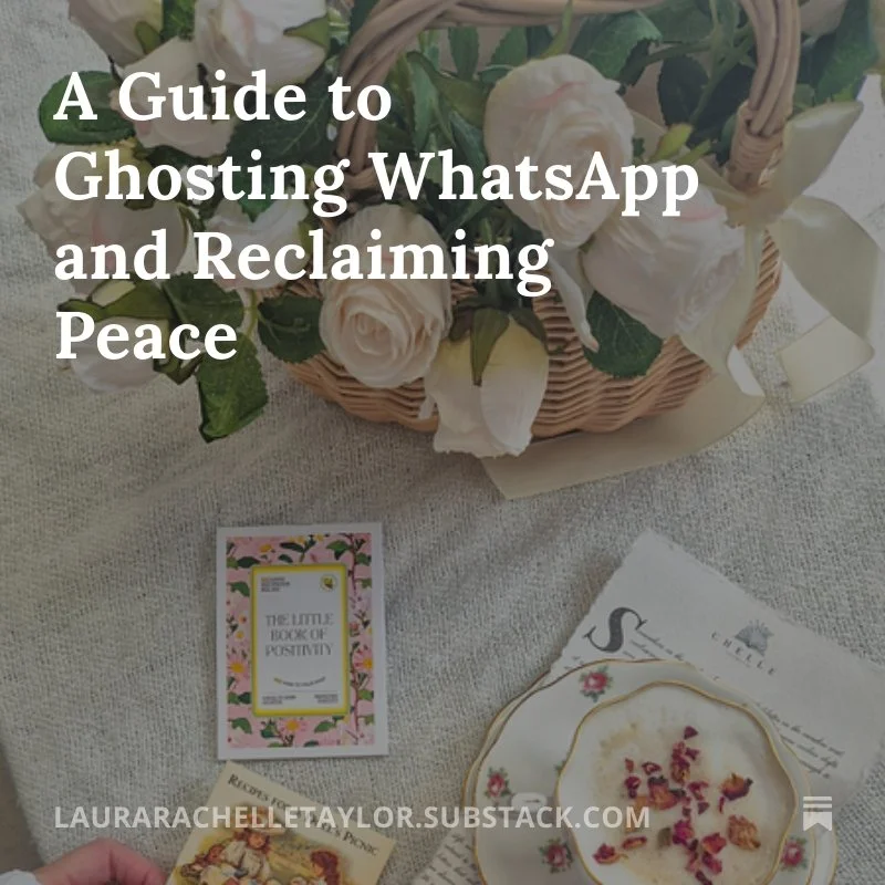 A basket of white roses and flowers on a table with a pink card titled "The Little Book of Positivity," a small floral plate with dried flower petals, and a partially visible white napkin with a printed message.