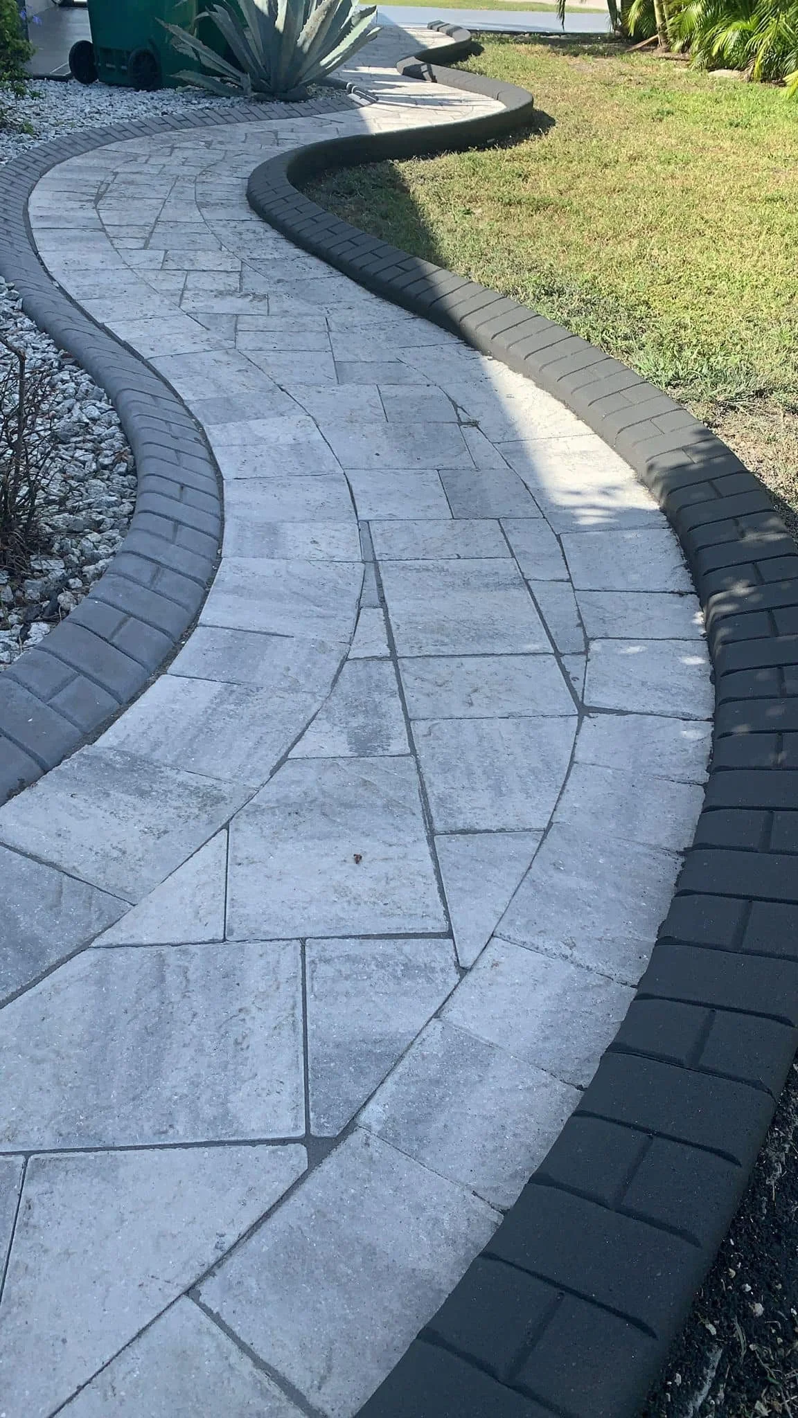 Paver walkway and concrete curbing installed by LD Lifestyles.