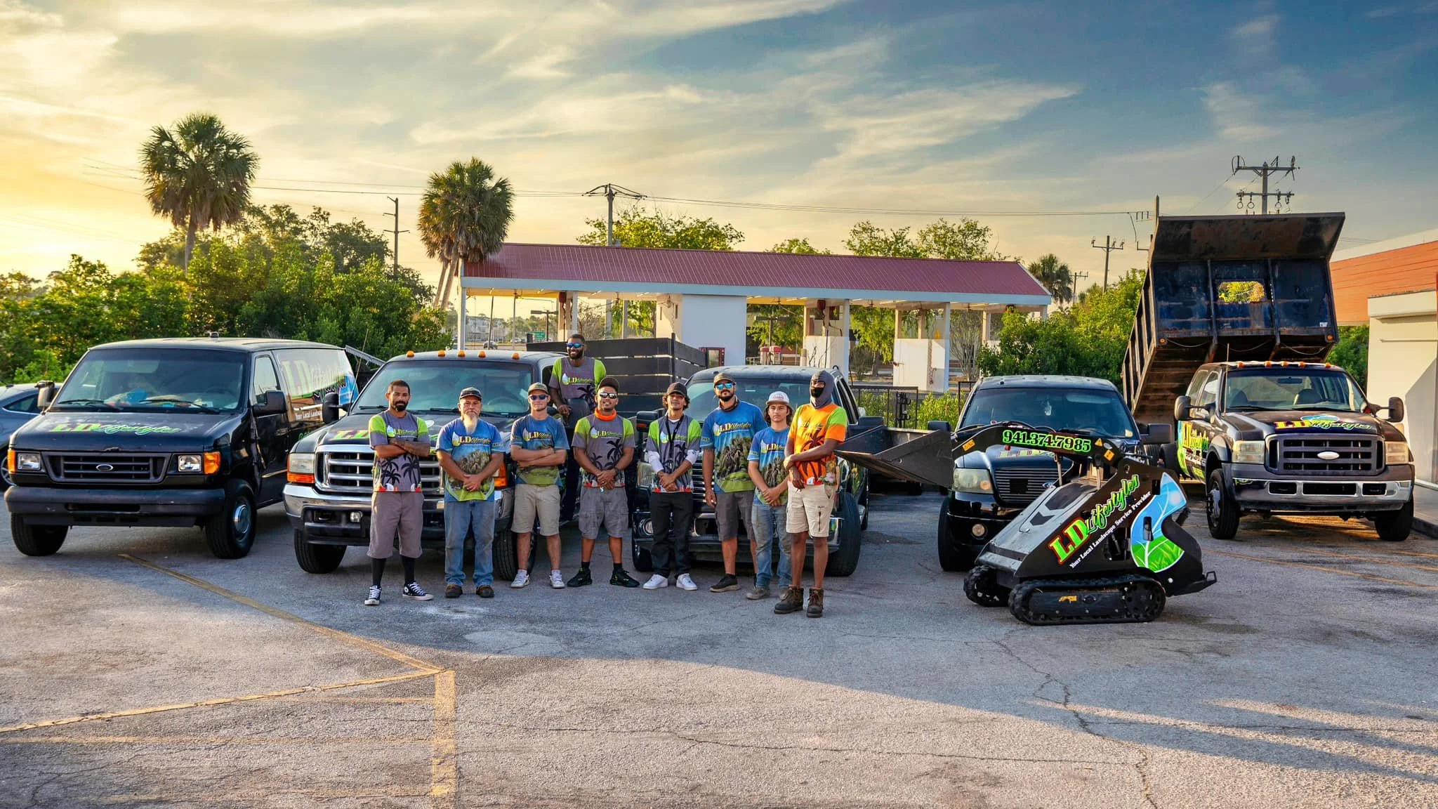 LD Lifestyles team standing in front of trucks and machines in Port Charlotte, FL.