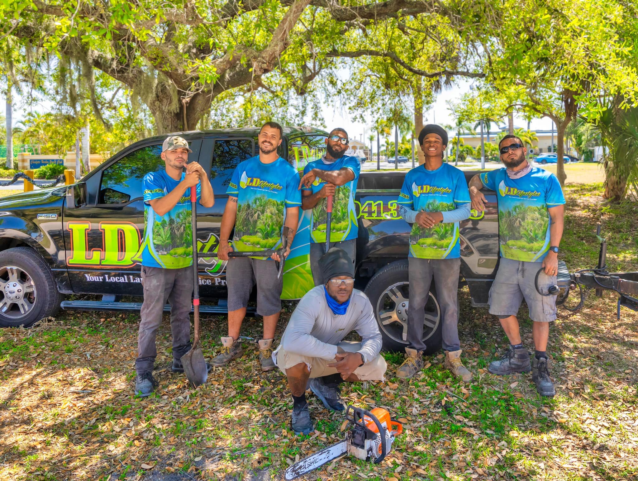 LD Lifestyles team in front of truck with landscaping tools in Port Charlotte.