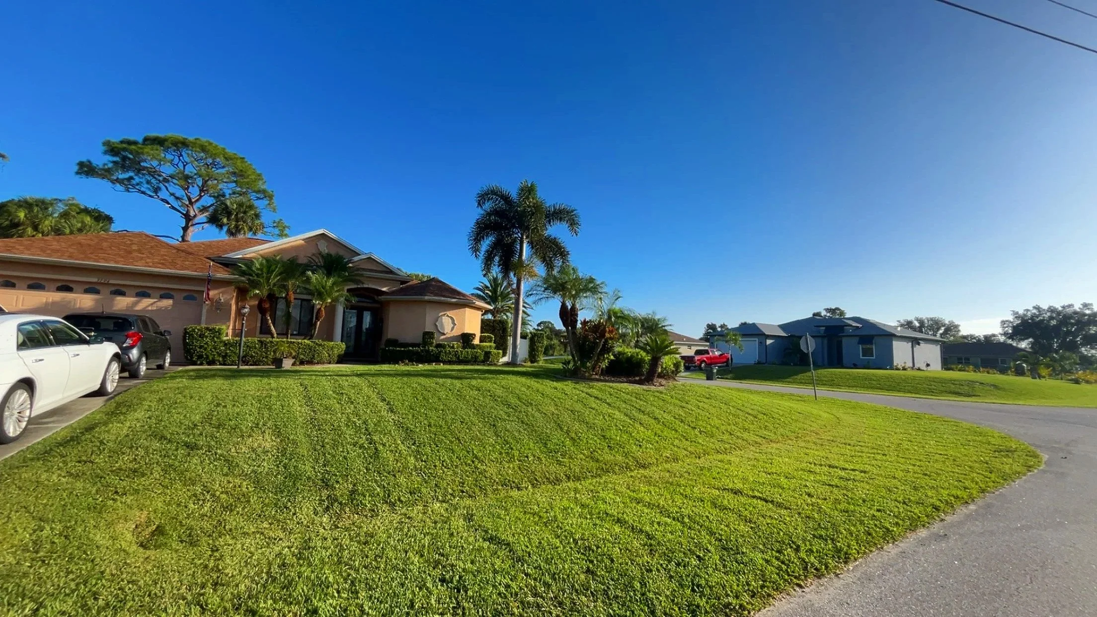 A residential home with a well-maintained front yard by LD Lifestyles with St. Augustine lawn in Port Charlotte Florida.
