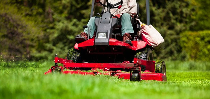LD Lifestyles employee riding a mower and maintaining a North Port lawn.
