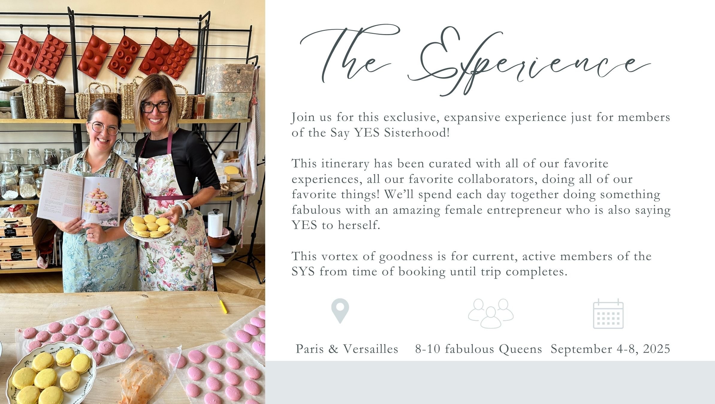 Two women standing in a kitchen, smiling, holding macarons and a cookbook, with a table of pink and yellow macarons in front of them. One woman wears glasses and a floral apron; the other wears glasses and a black shirt with a floral apron.