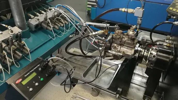 Laboratory equipment with various tubes, wires, and metallic components likely involved in scientific experimentation or engineering.