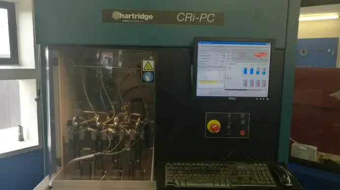 Laboratory machine with a computer screen, keyboard, and control panel, used for scientific testing or analysis.