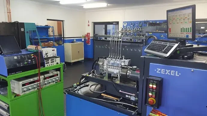 Laboratory with scientific equipment and machinery, including computers, control panels, and complex apparatus, used for scientific experiments or industrial testing.