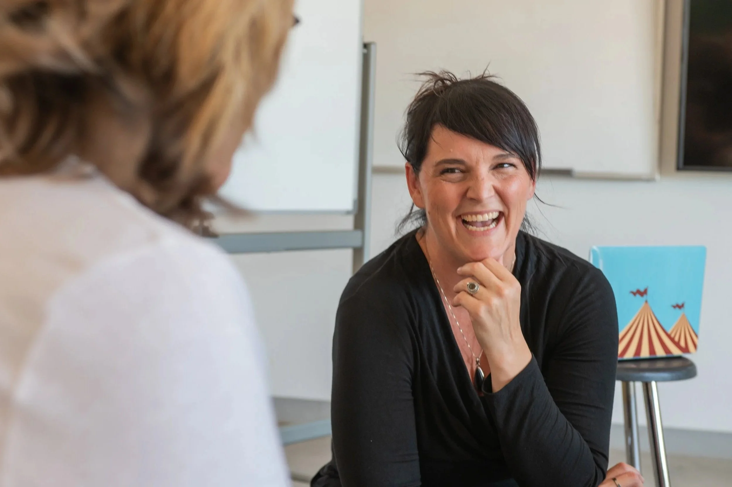 Hanna J. Miller laughing during a one-on-one leadership coaching conversation