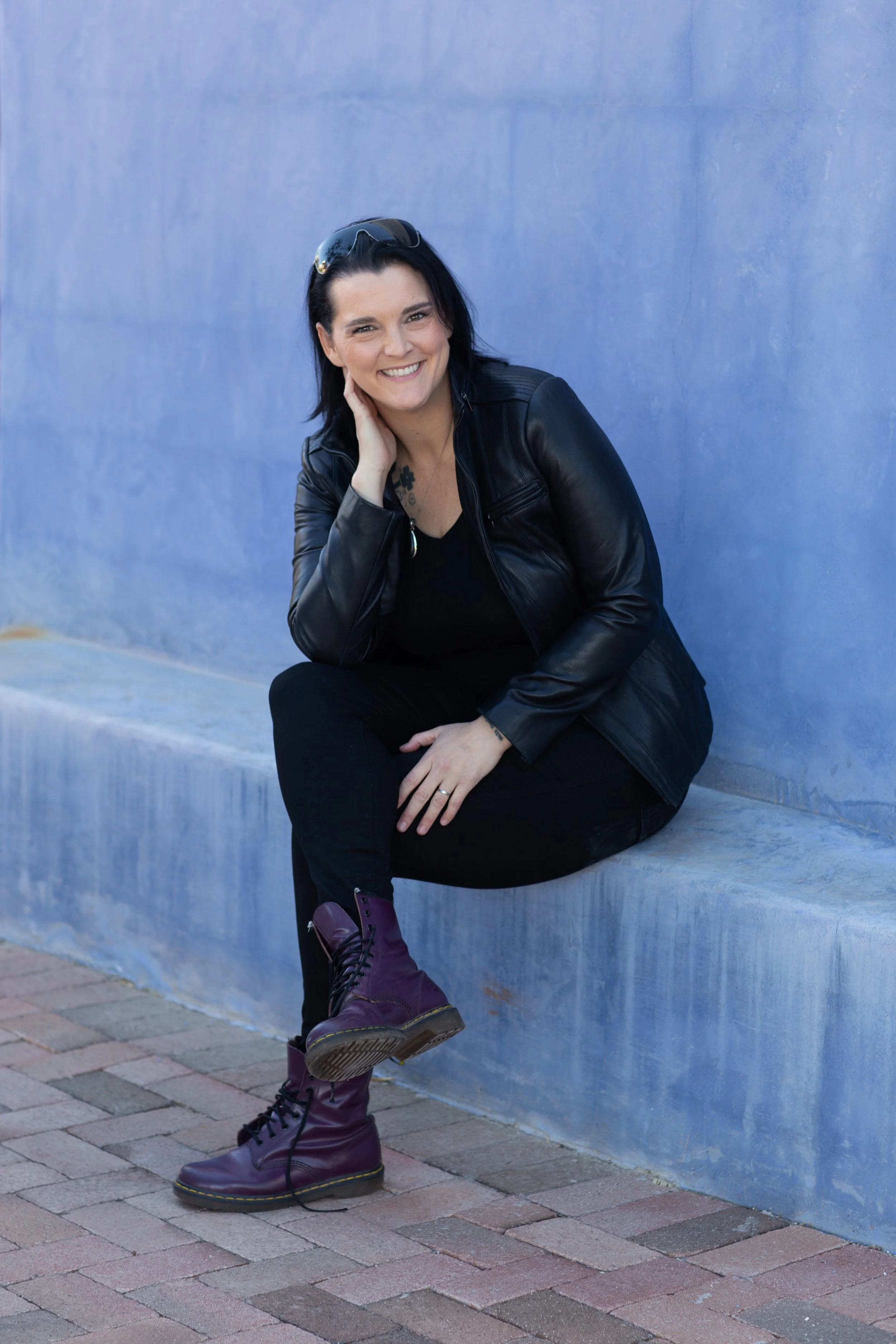 Leadership practitioner smiling while seated in an urban setting