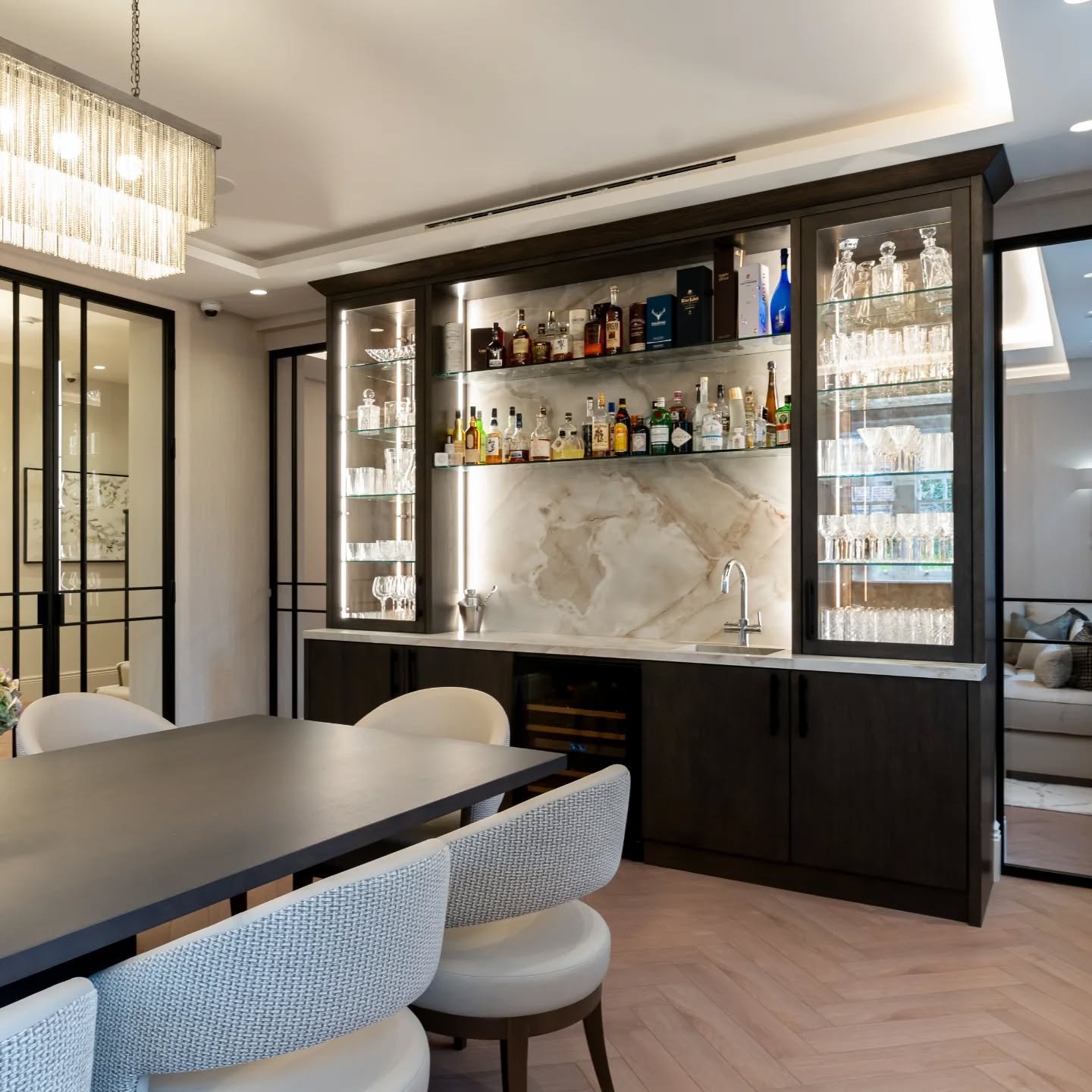 Luxury Home Bar

This home bar makes a bold statement in the dining room, with its dark-stained oak exterior beautifully contrasted by light porcelain countertops. Integrated LED lighting highlights the craftsmanship and adds a sleek, modern touch.

