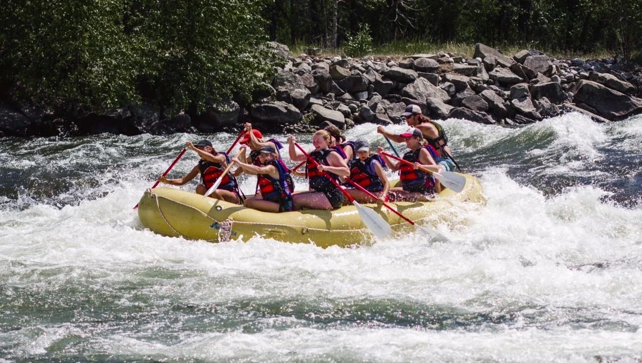 Adventure Whitewater guests paddle the  rapids on the Stillwater River