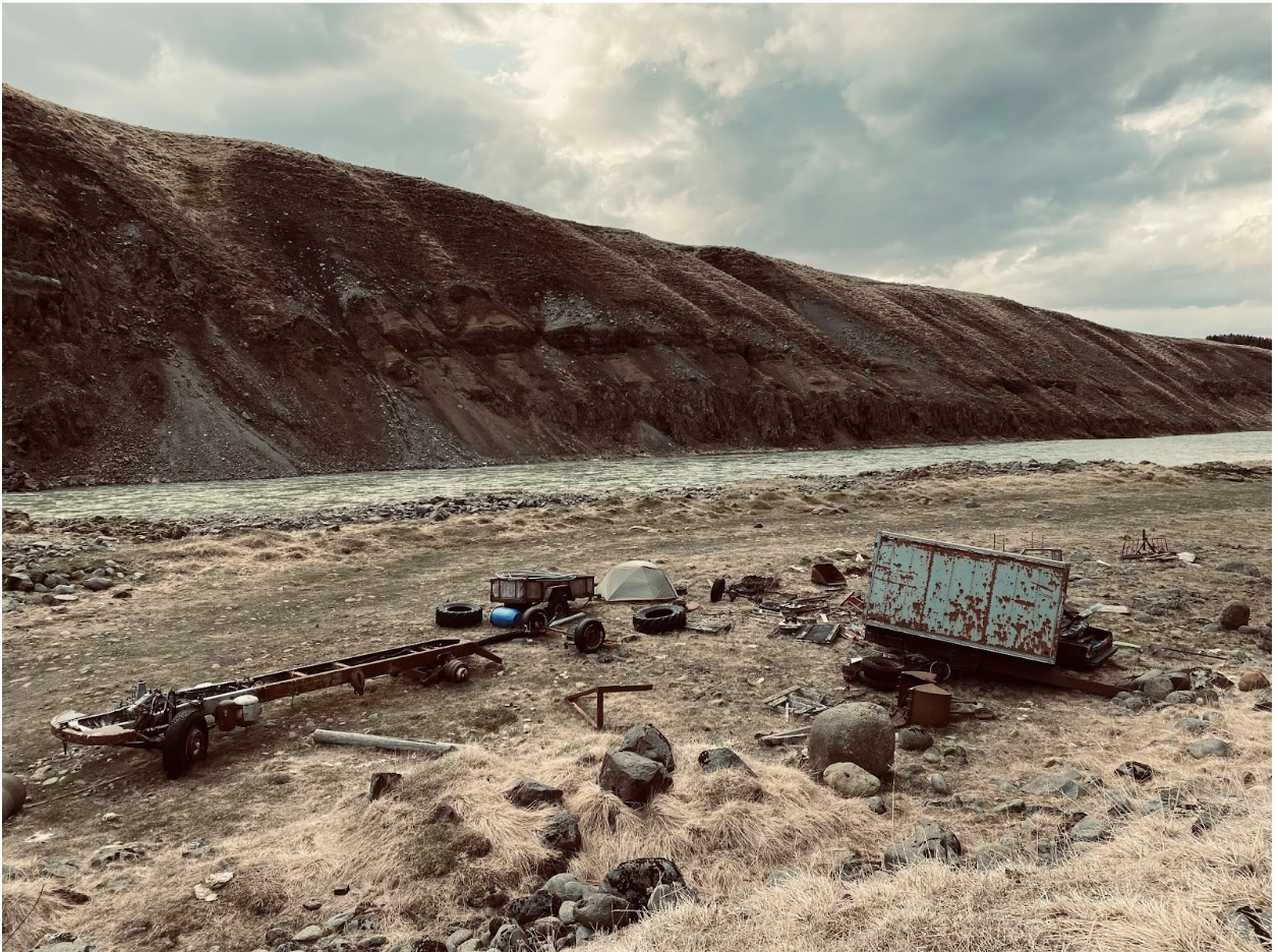 Tent pitched amongst a pile of trash