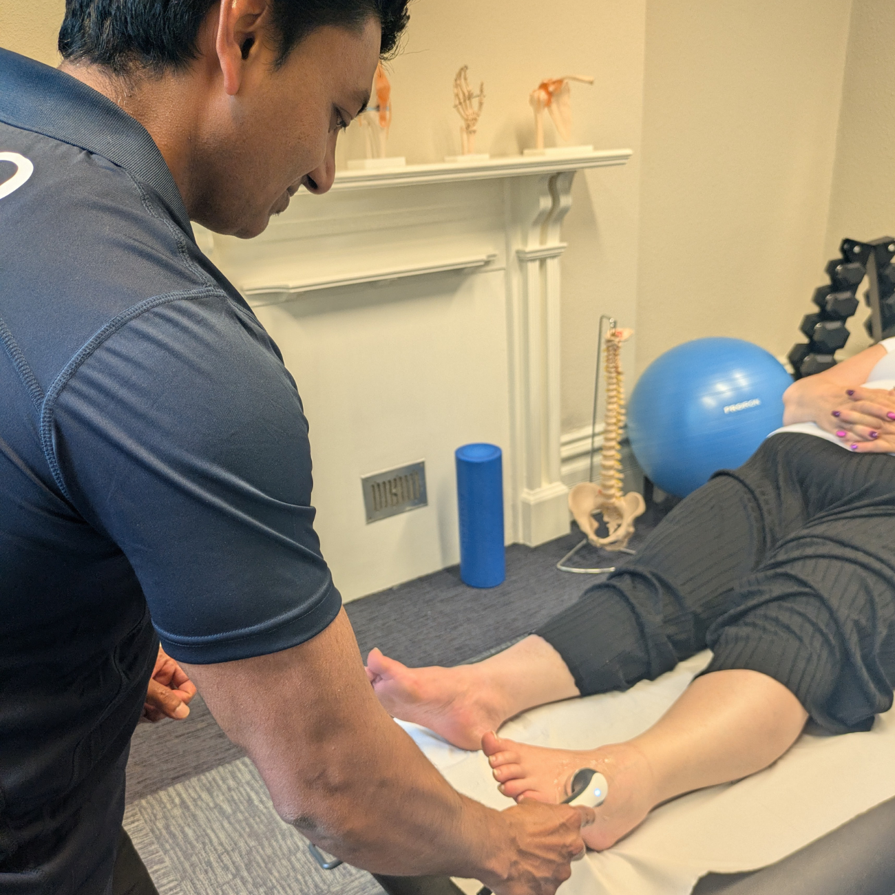 Raj (physio) applying ultrasound to a patients ankle