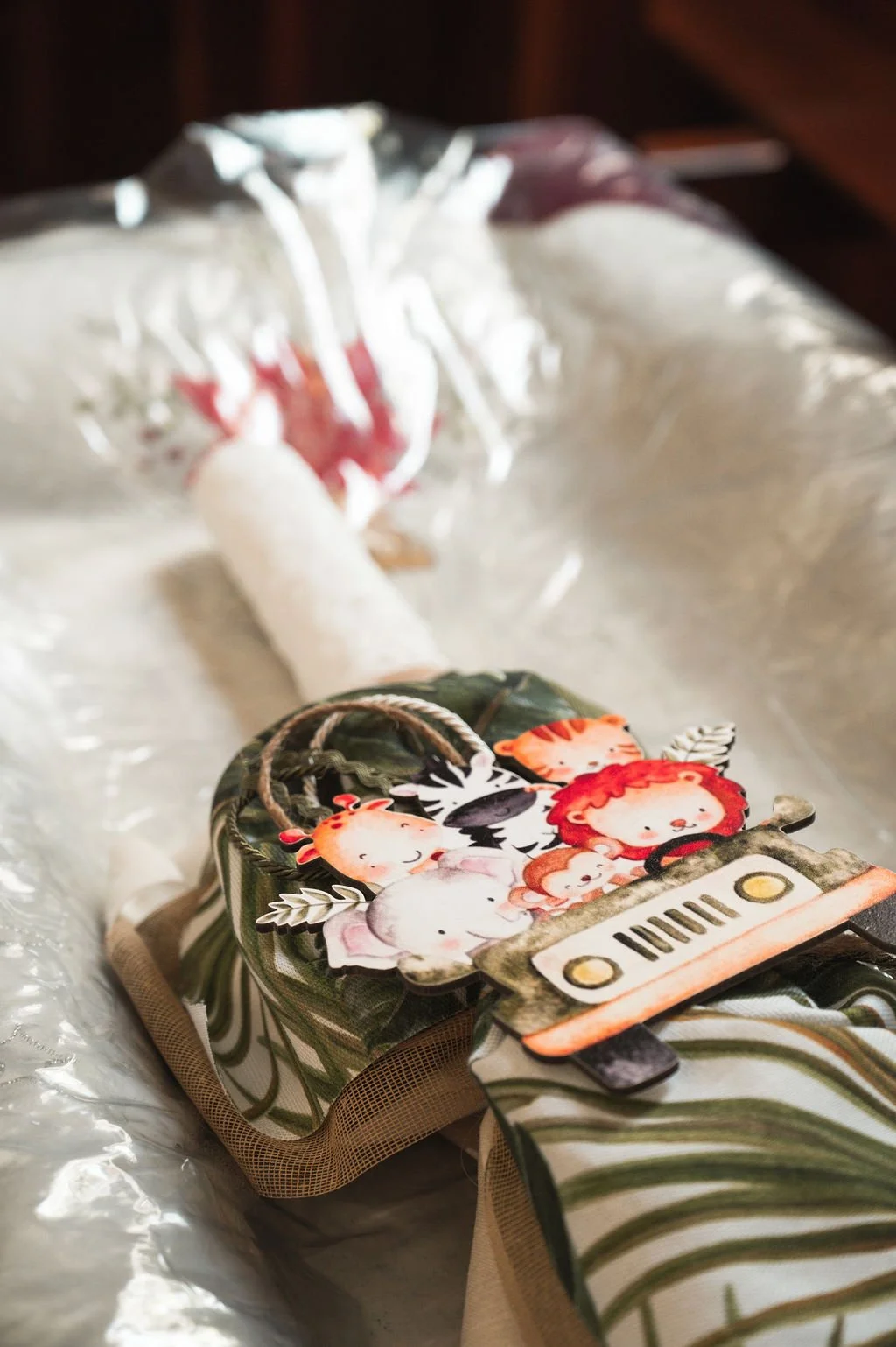 Children's drawing of animals and the word 'HUG' on a paper attached to a school bag.