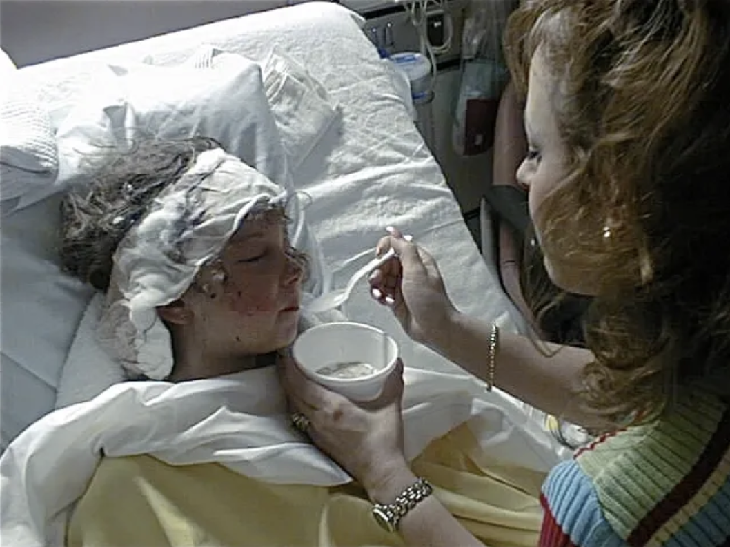 Raquel-in-hospital-with-bandage-around-her-head