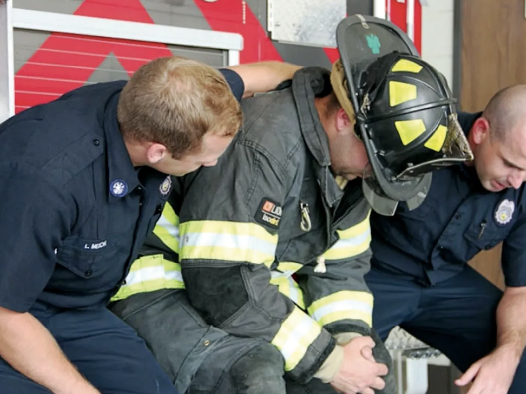 Fire-fighter-being-hugged-and-supported