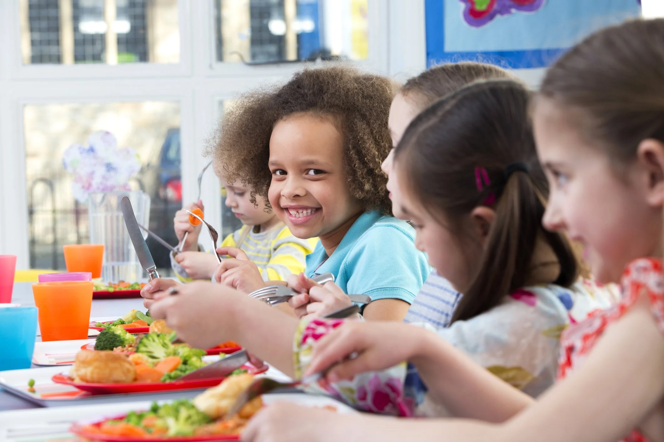 two-small-children-laughing-eating-food
