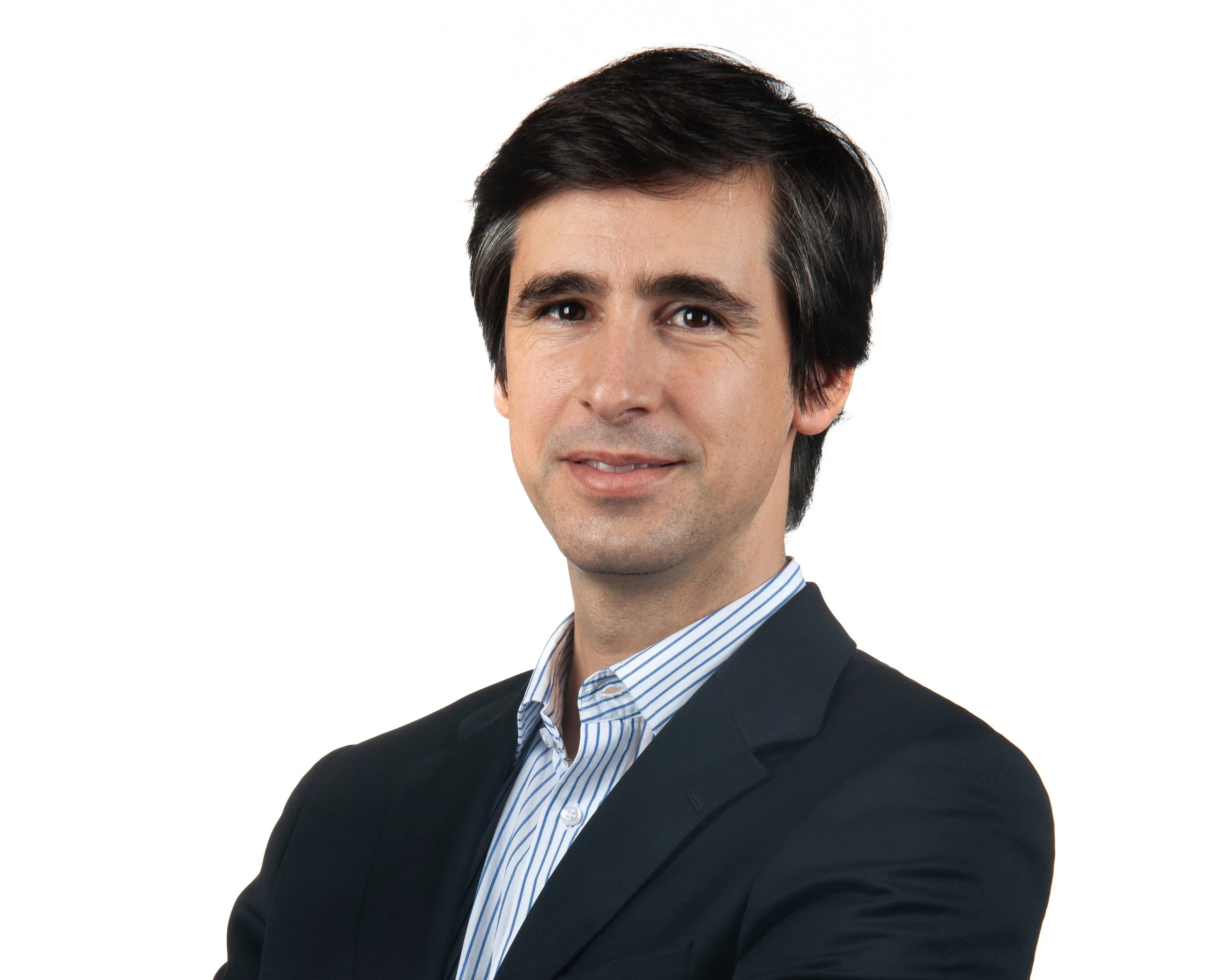 Portrait of a man in a suit with a light background.