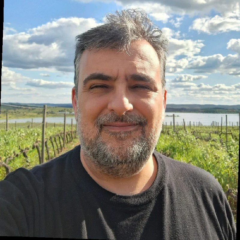 Man smiling in vineyard with clear sky