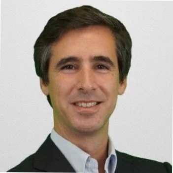 Smiling man in a suit with a light background