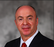 Bald man in a suit with a red tie