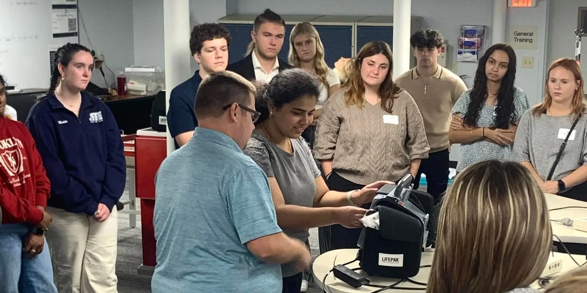 High school students test healthcare equipment during Raise the Bar Career Expo.