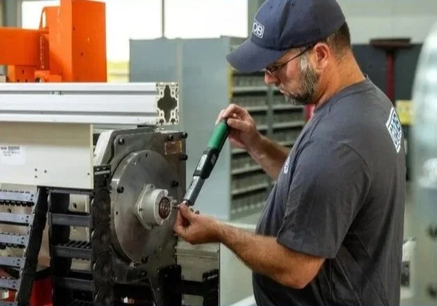GROB worker assembling machinery.