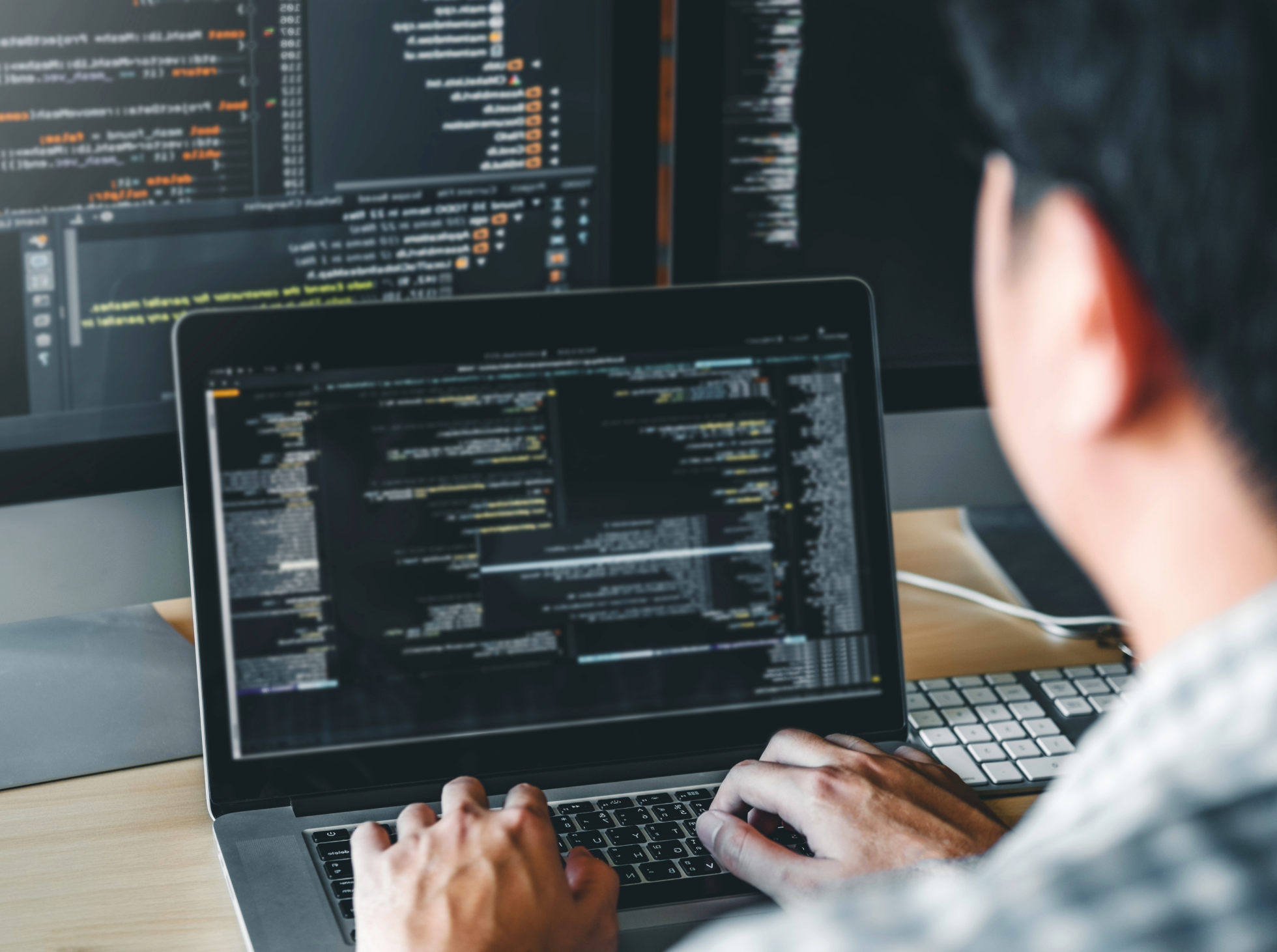A person coding on a computer.