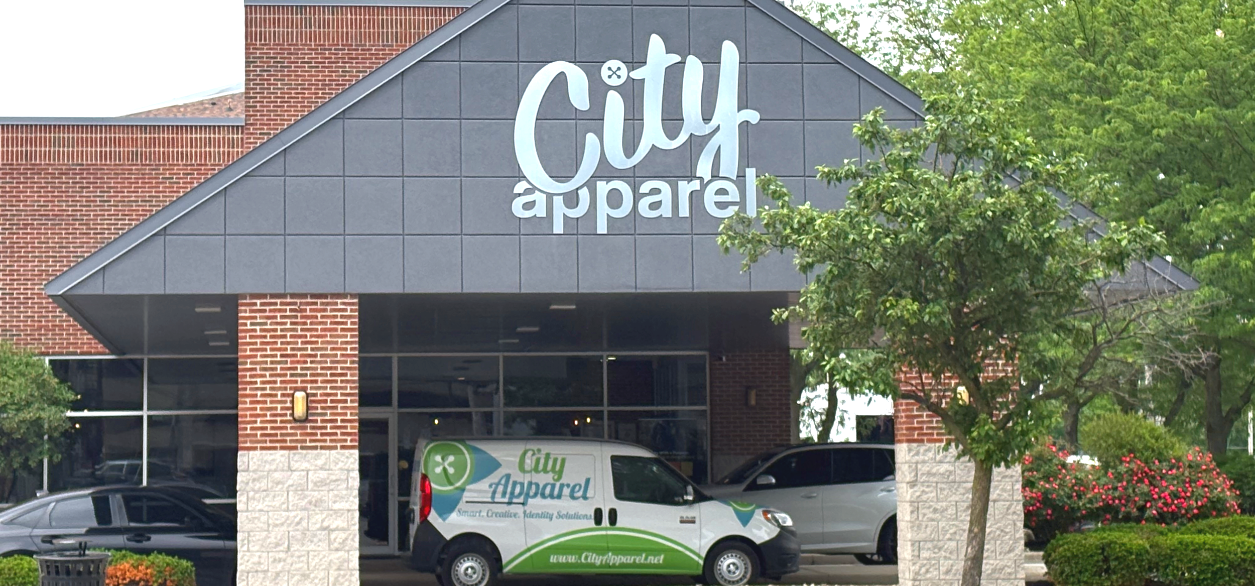Exterior of City Apparel and Merch, including a City Apparel branded van, on East Main Cross in Findlay, Ohio.