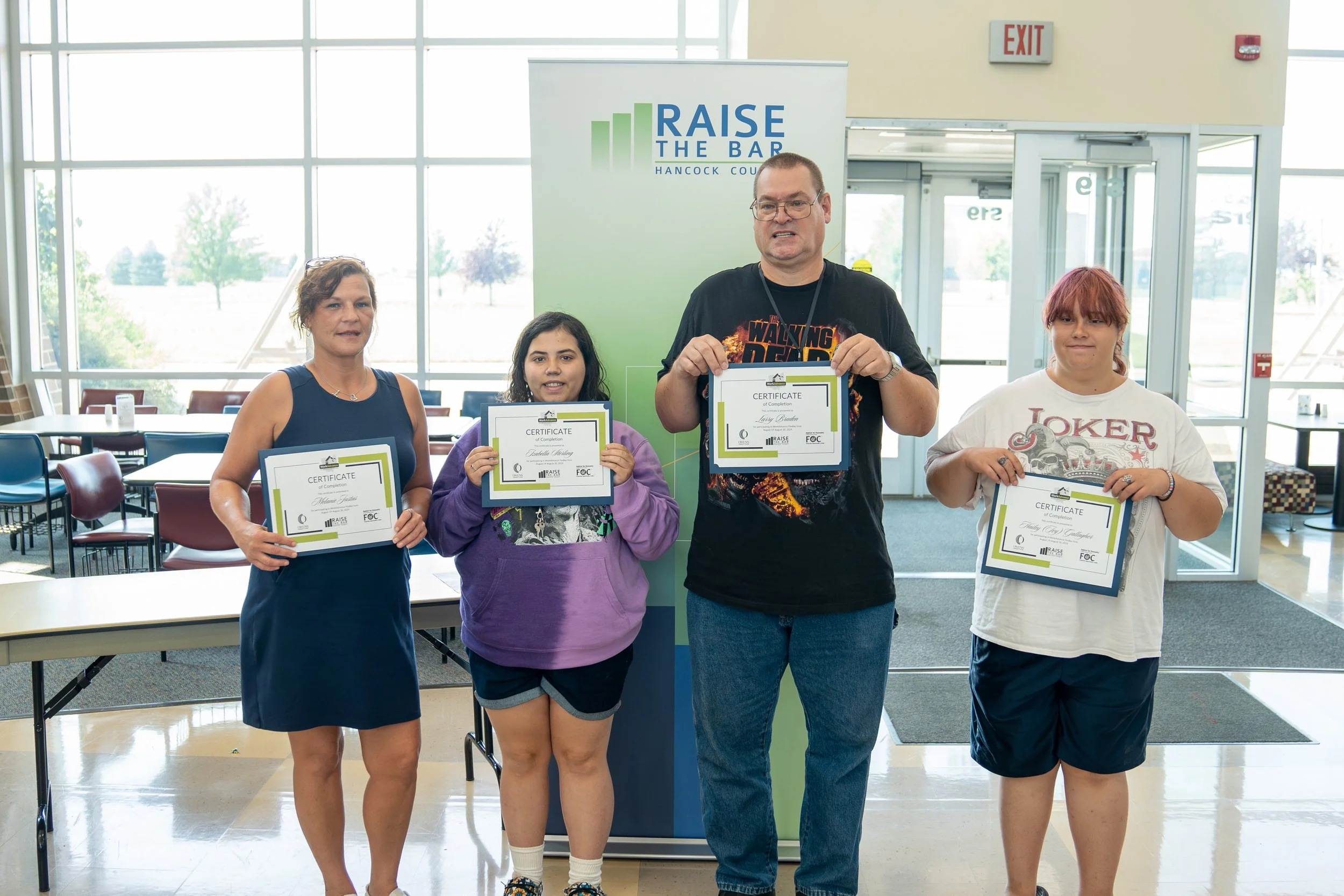 Four WorkAdvance Findlay graduates receiving their certificates of completion.