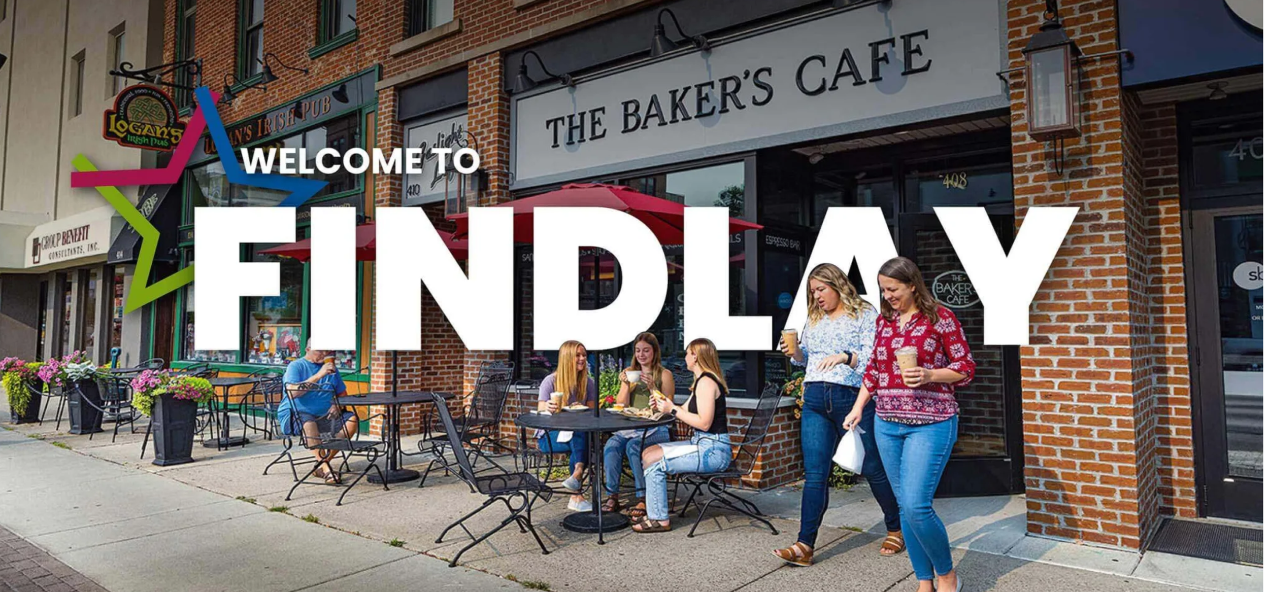 People sitting and standing outside a Findlay café on a sunny day.