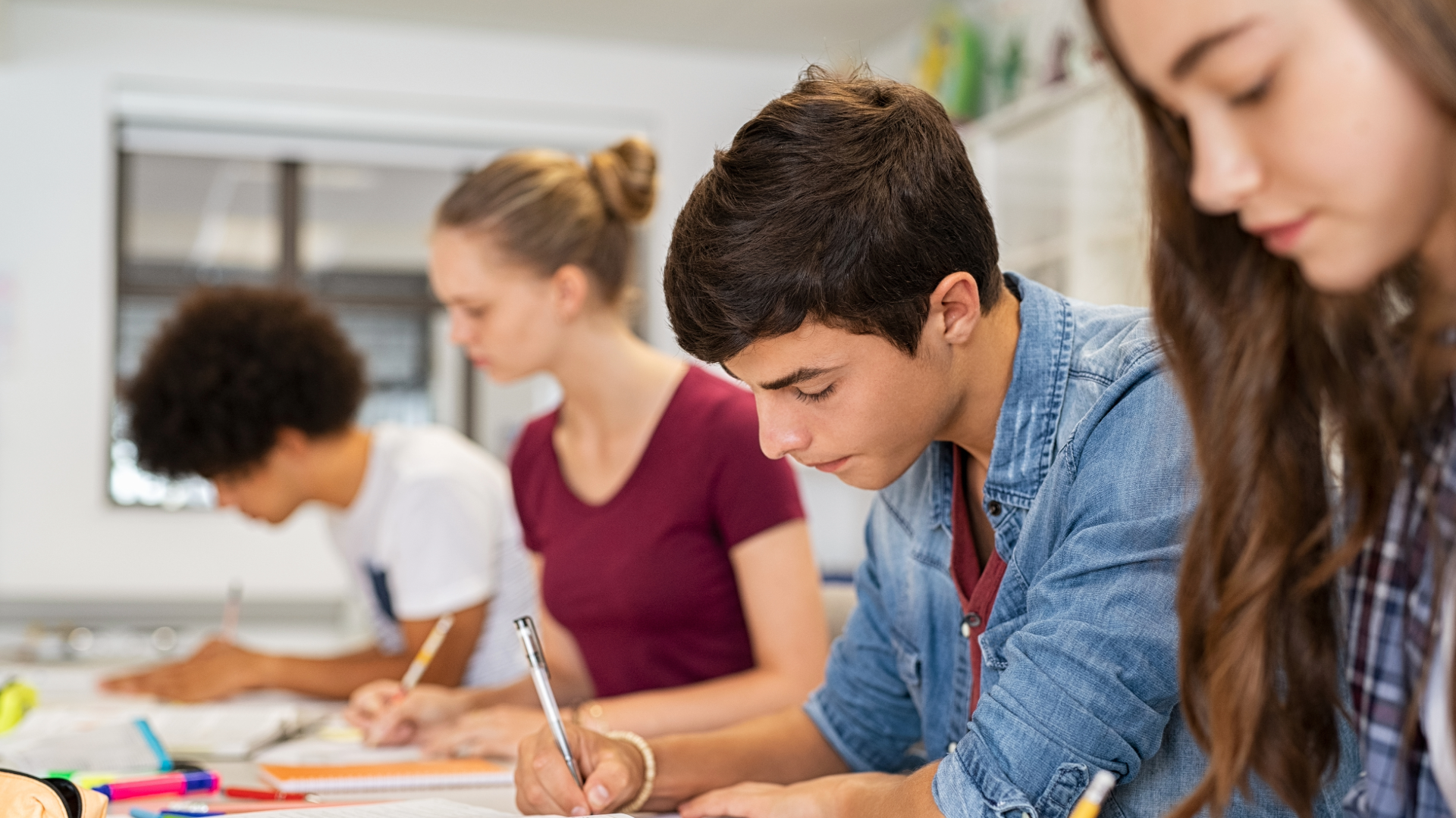 High school students working on written assignment.