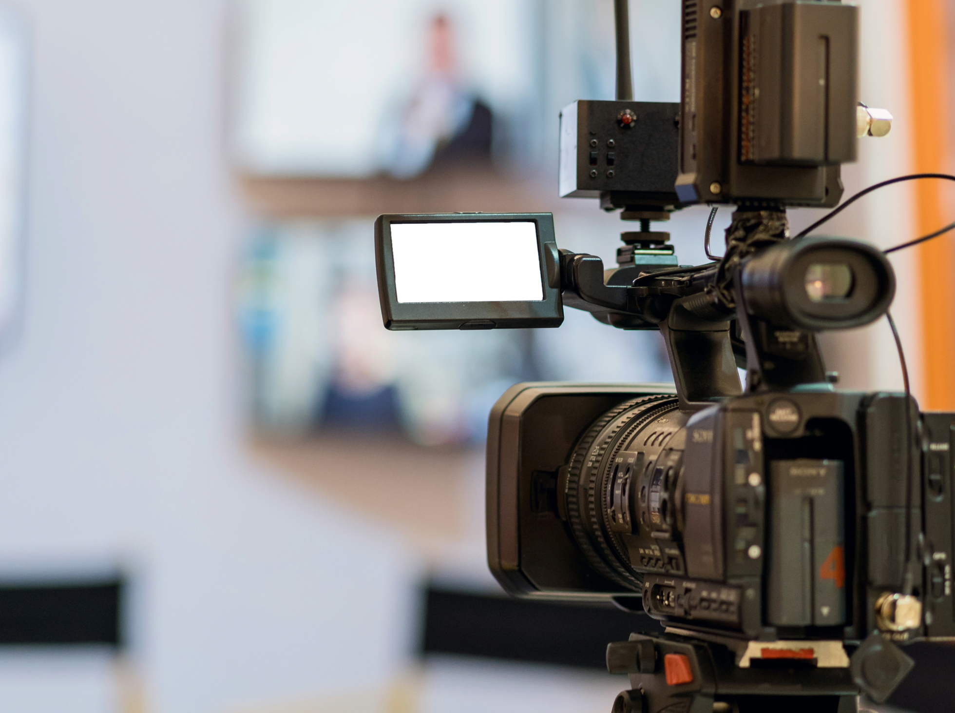 Close-up view of a professional video camera on a tripod.